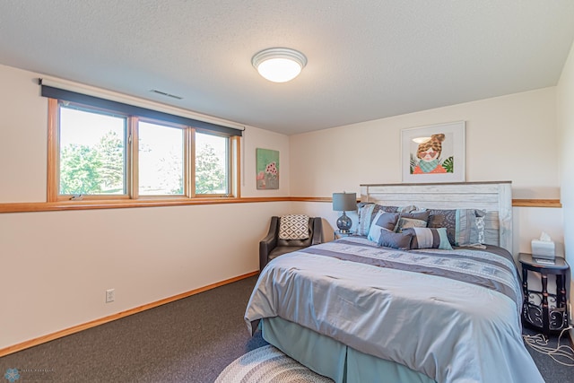 carpeted bedroom featuring a textured ceiling