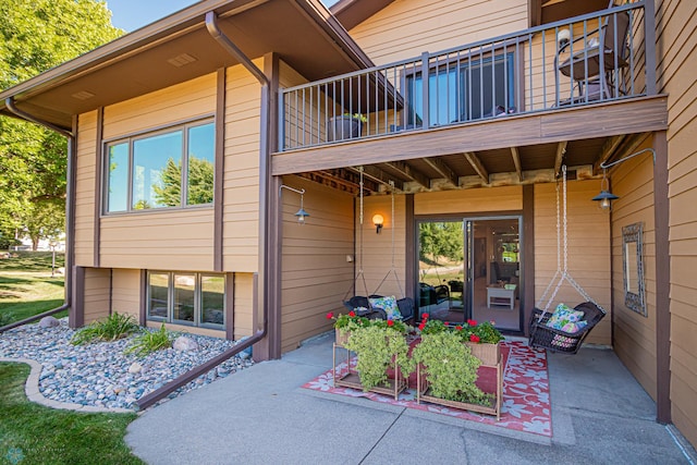 property entrance with a balcony and a patio area