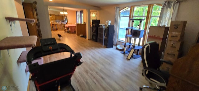 living room with wood-type flooring and an inviting chandelier