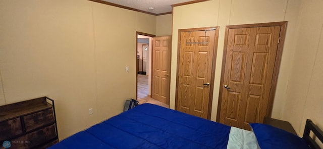 bedroom featuring hardwood / wood-style floors and crown molding