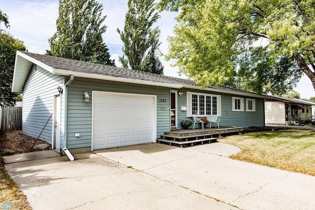 single story home with a front yard and a garage