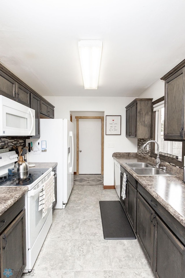 kitchen featuring white appliances, dark brown cabinetry, and sink