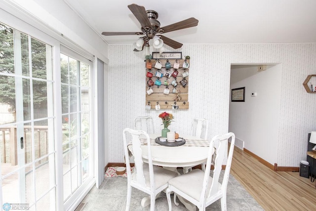 dining room with light hardwood / wood-style flooring, ceiling fan, and crown molding