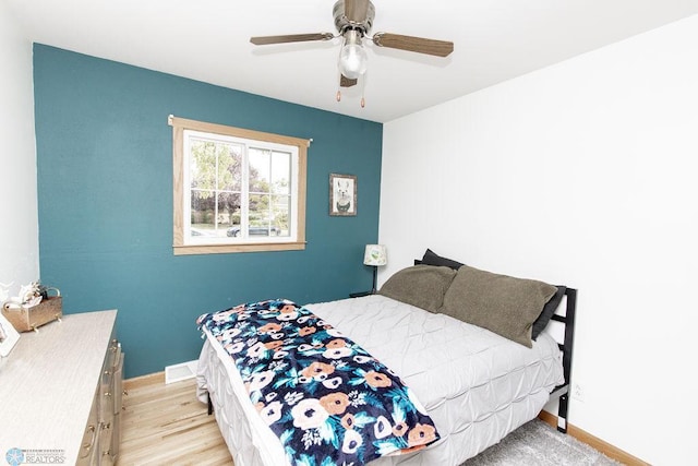 bedroom with ceiling fan and light hardwood / wood-style flooring