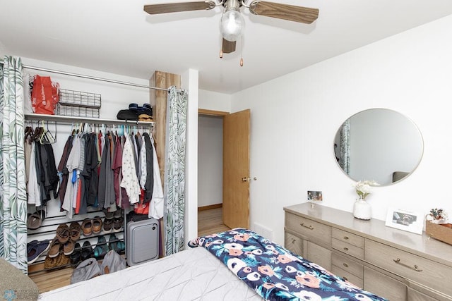 bedroom with ceiling fan, a closet, and hardwood / wood-style floors