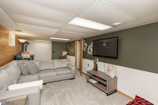 carpeted living room with a drop ceiling