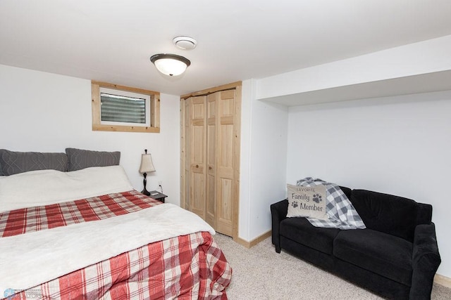 bedroom featuring light colored carpet and a closet