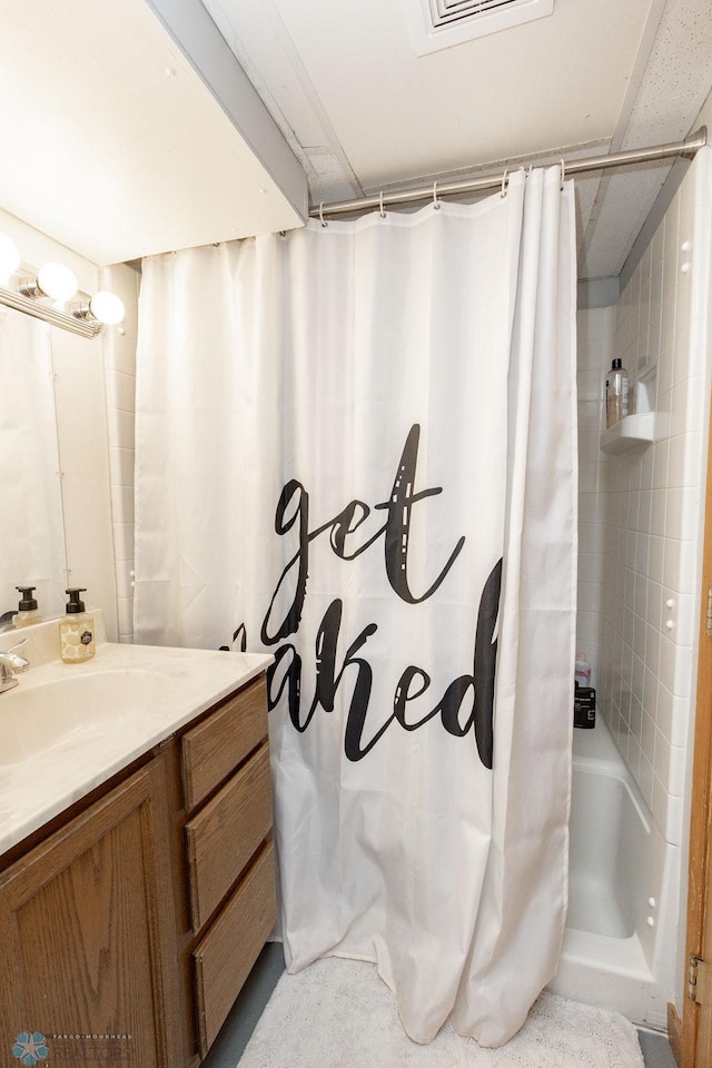 bathroom featuring vanity and curtained shower