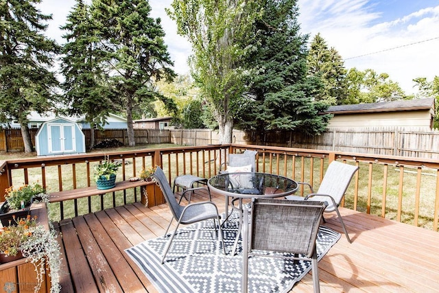 wooden deck featuring a storage shed and a yard