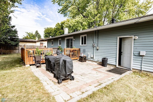 view of patio with a wooden deck and a grill