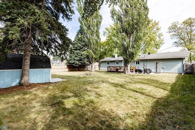 view of yard with a shed and a deck