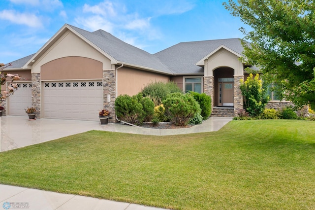 view of front of property with a garage and a front lawn