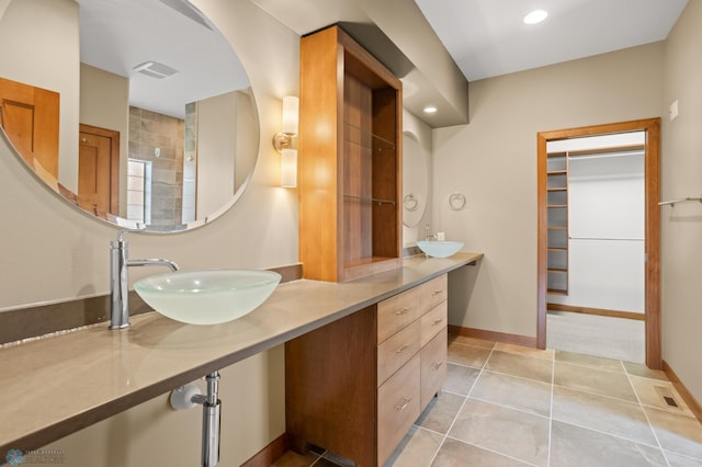 bathroom featuring tile patterned flooring and vanity