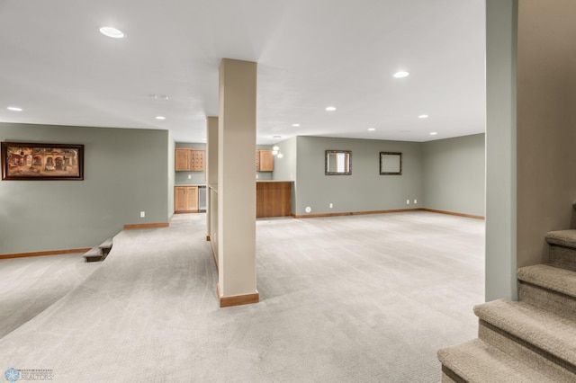 basement featuring light colored carpet