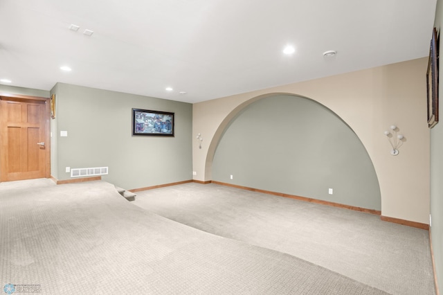 unfurnished room with light colored carpet