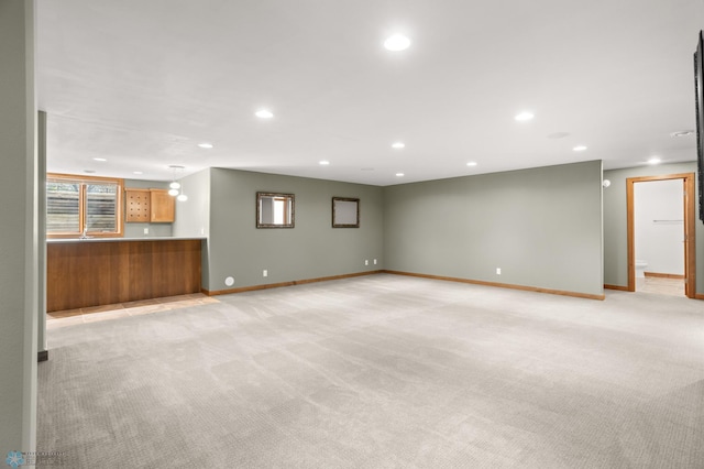 unfurnished living room featuring light carpet