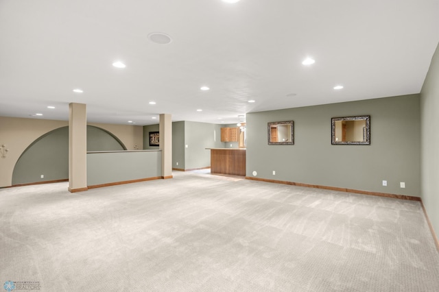 unfurnished living room with light colored carpet