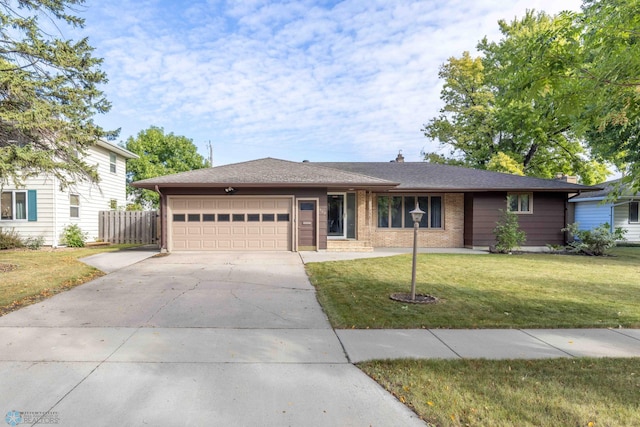 single story home with a garage and a front yard