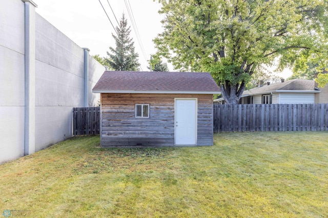 view of outdoor structure featuring a lawn