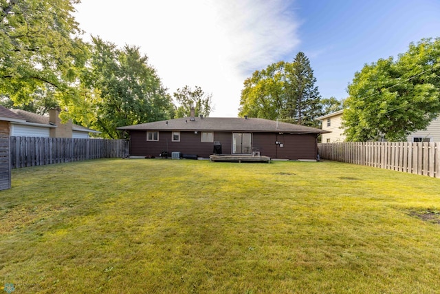 rear view of house featuring a lawn