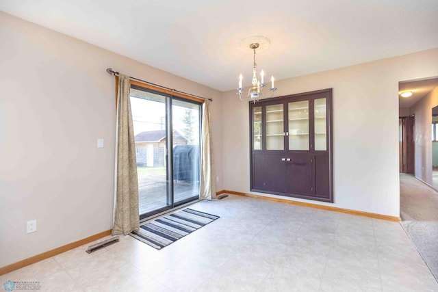 doorway to outside with a chandelier