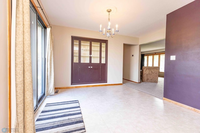 entryway with a chandelier