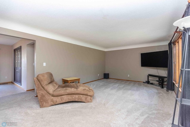 sitting room featuring light colored carpet