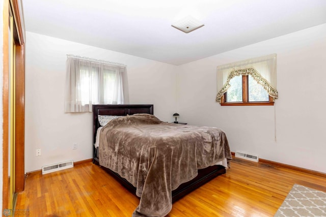 bedroom with wood-type flooring