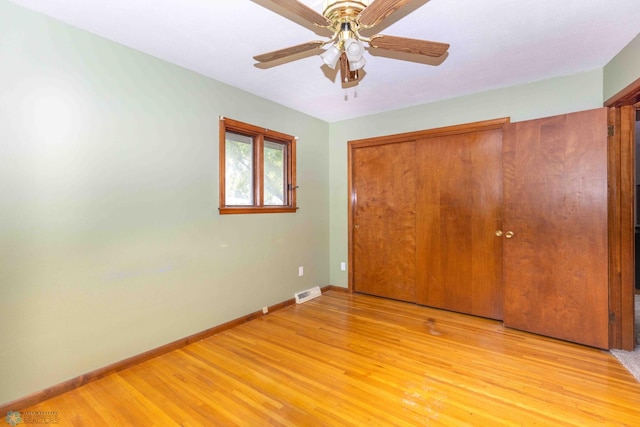 unfurnished bedroom featuring ceiling fan, a closet, and light hardwood / wood-style floors