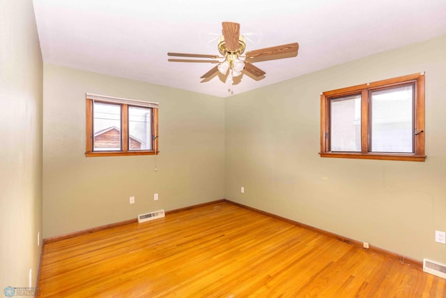 spare room with light wood-type flooring and ceiling fan