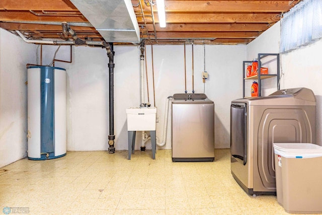 basement with washer and clothes dryer and water heater