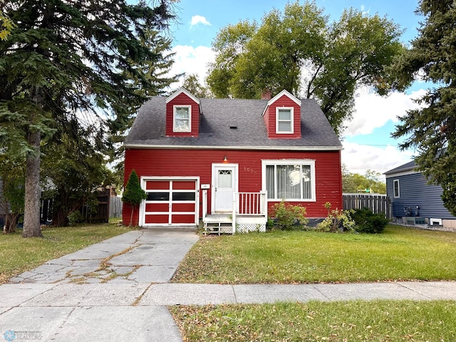 cape cod house with a front yard and a garage