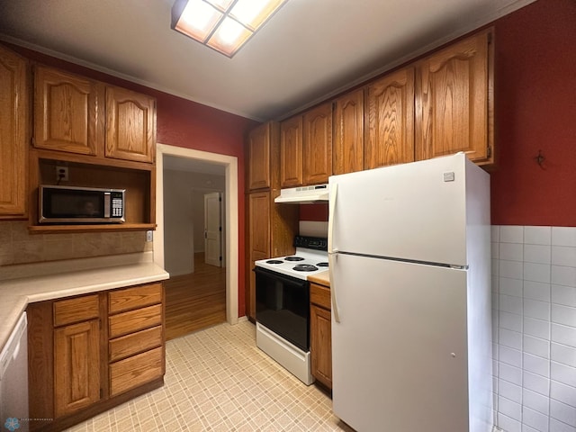 kitchen featuring light hardwood / wood-style flooring and white appliances