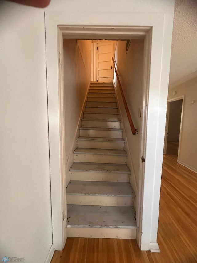 staircase featuring hardwood / wood-style flooring