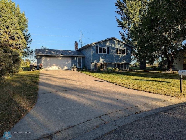 split level home featuring a garage and a front yard