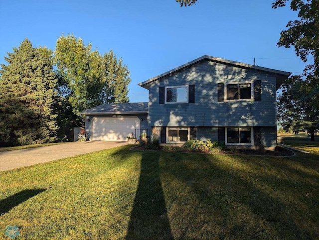 tri-level home with a garage and a front lawn