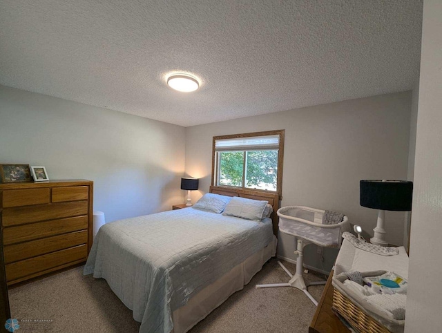 carpeted bedroom featuring a textured ceiling