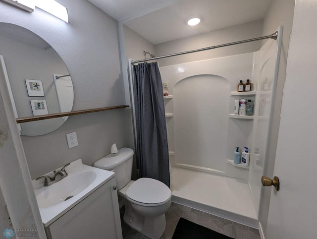 bathroom with vanity, toilet, and curtained shower