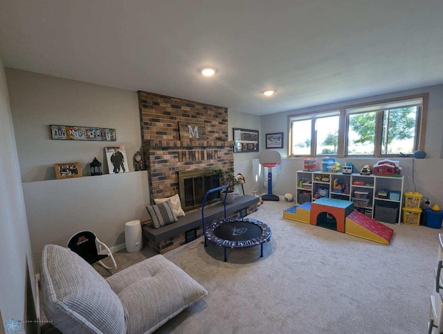 living room with a brick fireplace and carpet floors