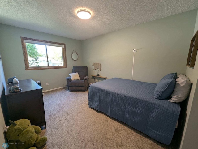 carpeted bedroom featuring a textured ceiling