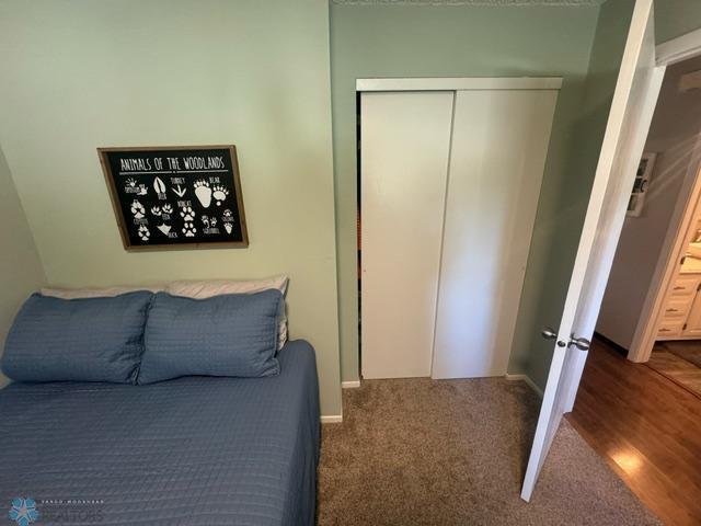 bedroom with a closet and dark hardwood / wood-style flooring