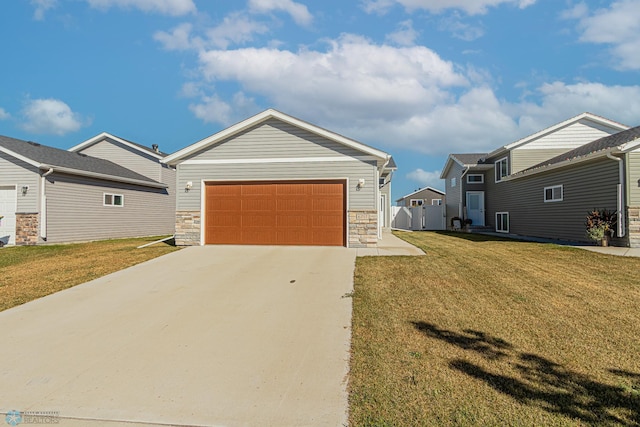 view of front of property featuring a front yard, a garage, and a storage unit