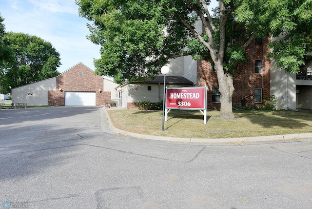 view of front of property with a front yard and a garage