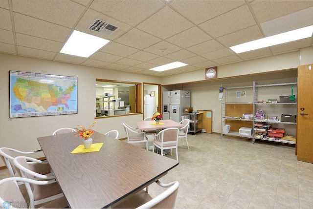 dining area with a paneled ceiling