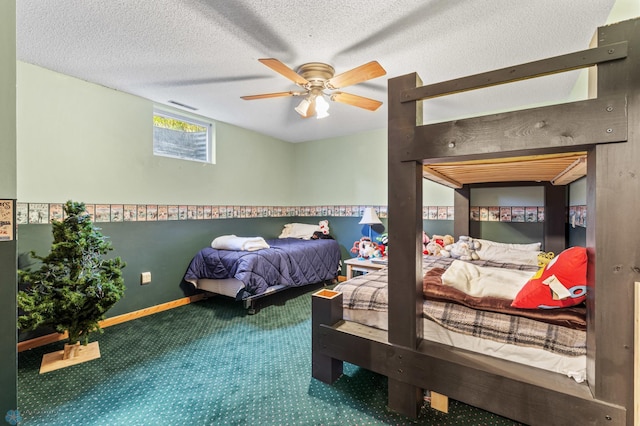 carpeted bedroom with ceiling fan and a textured ceiling