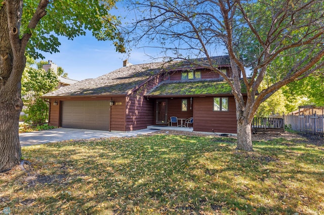 ranch-style house featuring a front yard and a garage