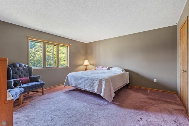 carpeted bedroom featuring a textured ceiling