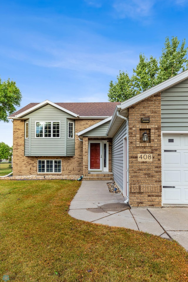 view of front of property with a front lawn and a garage