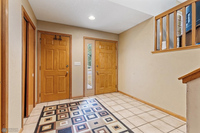 foyer entrance with light tile patterned floors