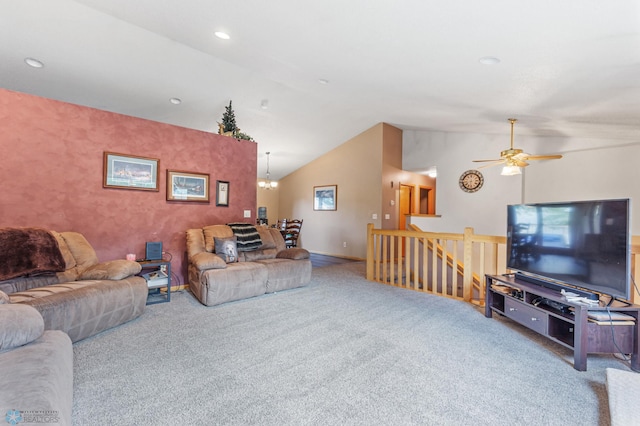 carpeted living room featuring ceiling fan with notable chandelier and high vaulted ceiling